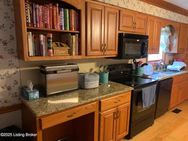 5309 Bardstown Rd, Springfield, KY 40069 - kitchen featuring black appliances, wallpapered walls, brown cabinets, light stone countertops, and light wood-type flooring