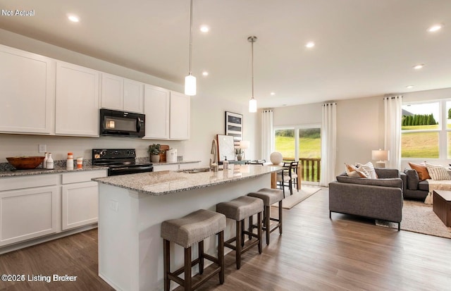 1853 Washington Blvd, Lyndon, KY 40242 - kitchen featuring black appliances, a sink, open floor plan, wood finished floors, and a kitchen island with sink