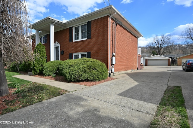 7514 Pimlico Dr, Louisville, KY 40214 - view of property exterior with an outbuilding, a garage, and brick siding