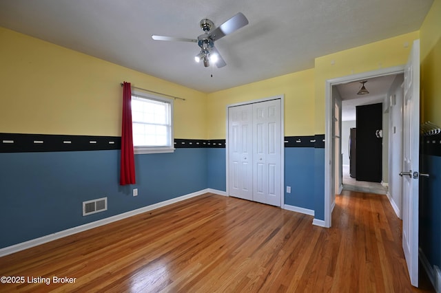 7514 Pimlico Dr, Louisville, KY 40214 - unfurnished bedroom with wood finished floors, baseboards, a closet, and a ceiling fan