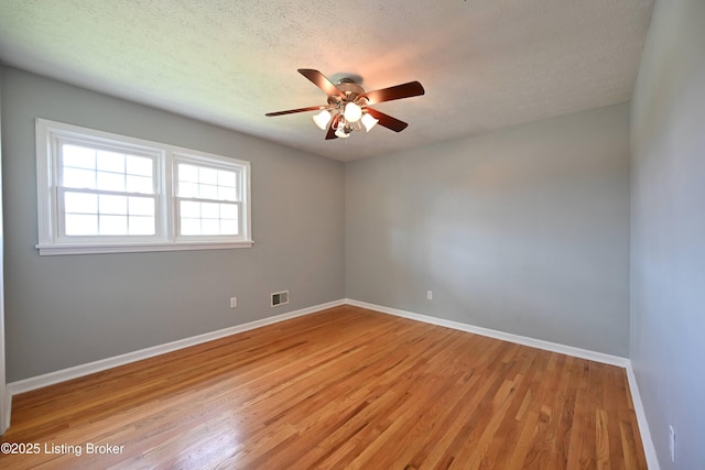 7514 Pimlico Dr, Louisville, KY 40214 - unfurnished room with light wood-style floors, a ceiling fan, baseboards, and a textured ceiling