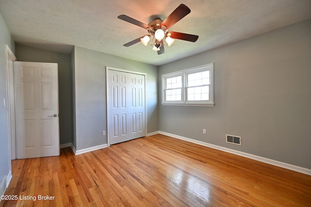 7514 Pimlico Dr, Louisville, KY 40214 - unfurnished bedroom featuring baseboards, light wood-style floors, a textured ceiling, a closet, and ceiling fan