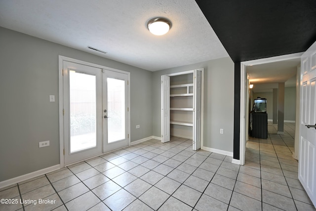 7514 Pimlico Dr, Louisville, KY 40214 - unfurnished bedroom with light tile patterned floors, french doors, access to exterior, a closet, and a textured ceiling