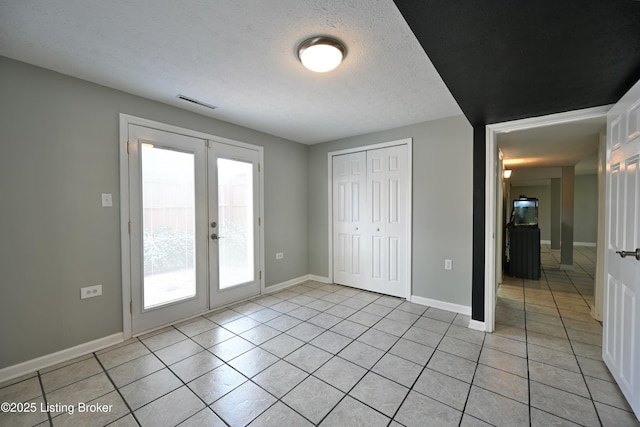 7514 Pimlico Dr, Louisville, KY 40214 - unfurnished bedroom with light tile patterned flooring, access to exterior, french doors, baseboards, and a textured ceiling