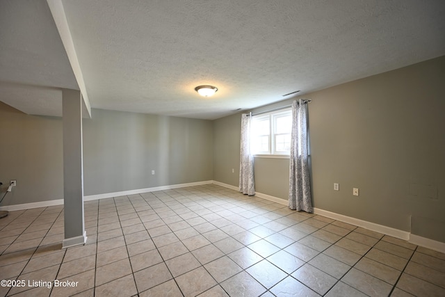 7514 Pimlico Dr, Louisville, KY 40214 - empty room featuring a textured ceiling, light tile patterned floors, and baseboards