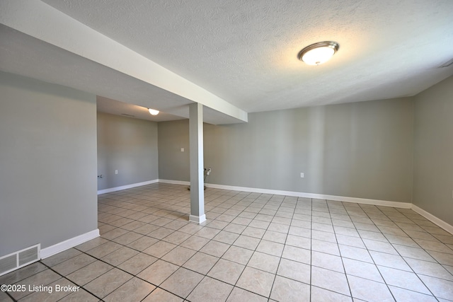 7514 Pimlico Dr, Louisville, KY 40214 - finished basement with a textured ceiling, light tile patterned floors, and baseboards