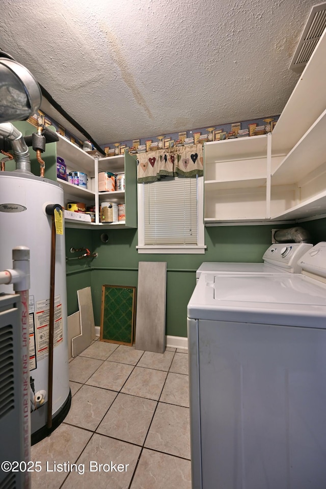 7514 Pimlico Dr, Louisville, KY 40214 - laundry area with washer and clothes dryer, gas water heater, light tile patterned flooring, and a textured ceiling