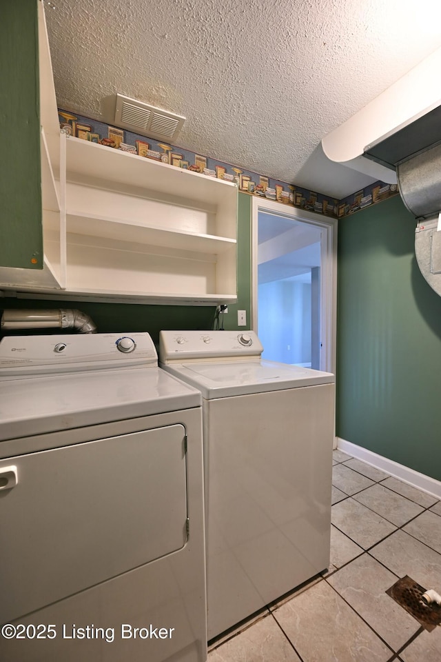 7514 Pimlico Dr, Louisville, KY 40214 - laundry room featuring washer and dryer, a textured ceiling, light tile patterned flooring, and baseboards