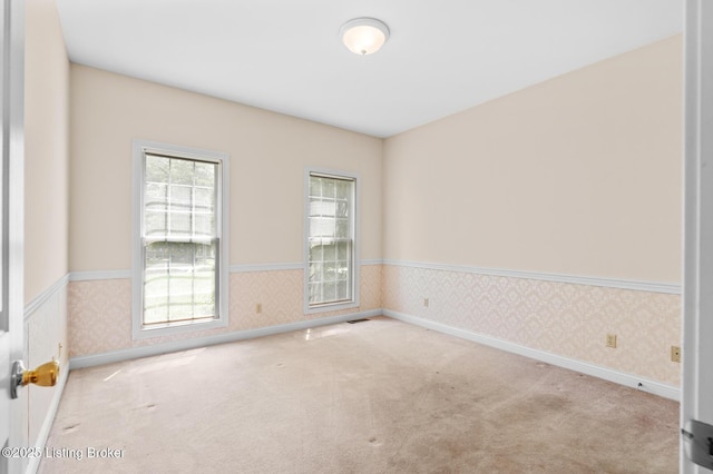 966 Lawrence St, Brandenburg, KY 40108 - carpeted empty room with wallpapered walls, healthy amount of natural light, and a wainscoted wall