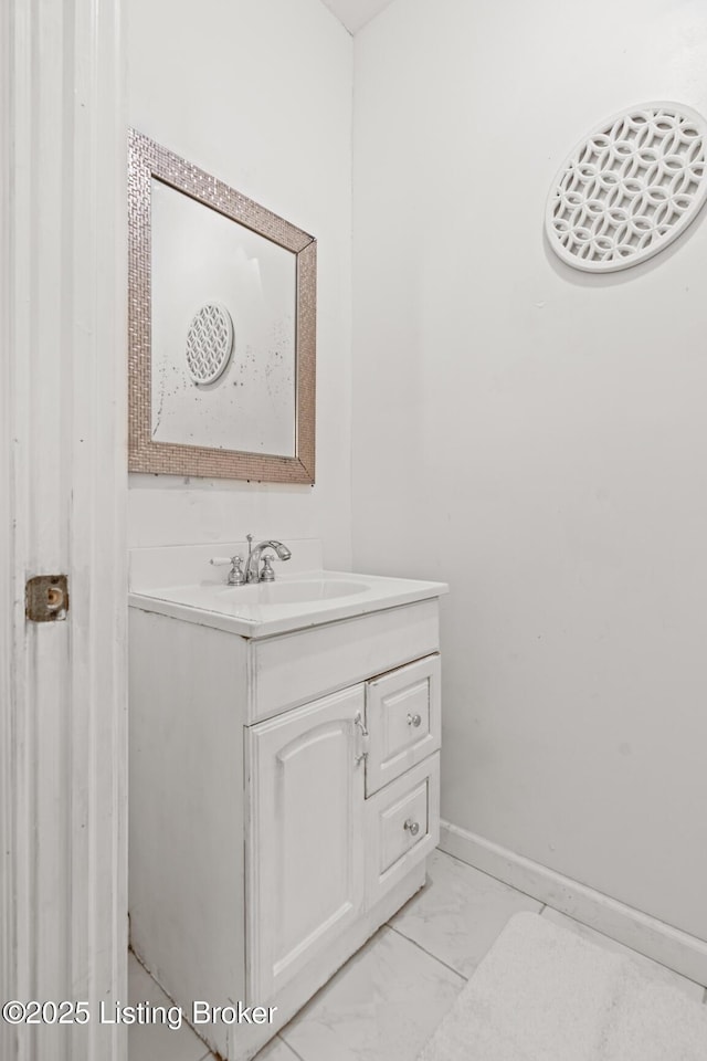 823 S Jackson St, Louisville, KY 40203 - bathroom featuring vanity, marble look tiles, and baseboards