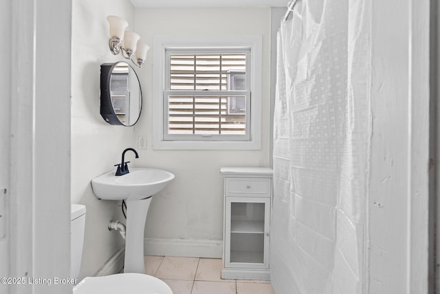 823 S Jackson St, Louisville, KY 40203 - bathroom featuring toilet, tile patterned floors, and baseboards