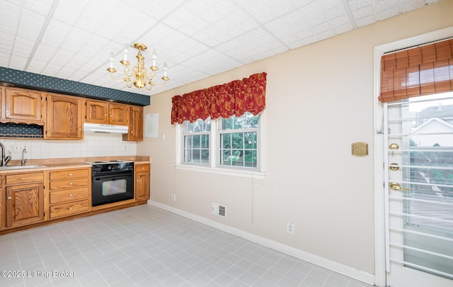 7212 Peppermill Ct, Louisville, KY 40228 - kitchen with a sink, light countertops, black oven, a chandelier, and decorative backsplash