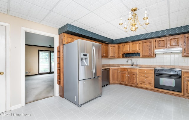 7212 Peppermill Ct, Louisville, KY 40228 - kitchen with stainless steel appliances, a sink, under cabinet range hood, light countertops, and a chandelier