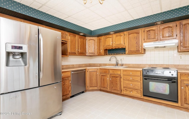 7212 Peppermill Ct, Louisville, KY 40228 - kitchen featuring appliances with stainless steel finishes, a sink, under cabinet range hood, light countertops, and brown cabinetry