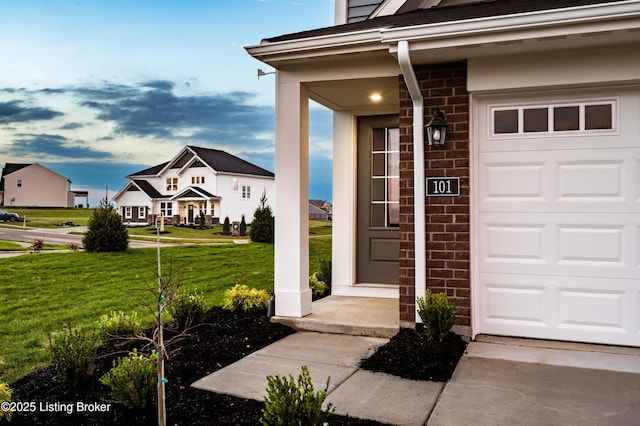 101 Exploration Unit 61A, Shelbyville, KY 40065 - doorway to property with a lawn, brick siding, a garage, and stone siding