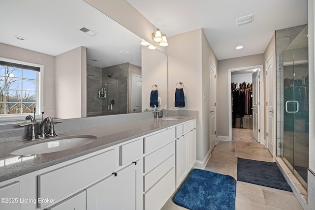 18001 Teton Ridge Ct, Louisville, KY 40245 - full bathroom with double vanity, a shower stall, a walk in closet, recessed lighting, and baseboards
