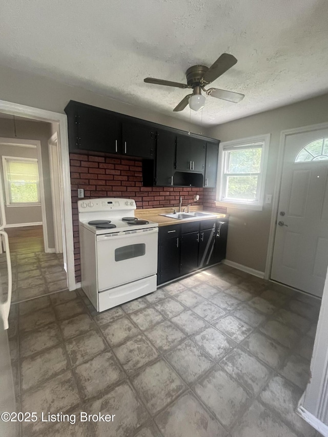 533 Lee Rd, Elizabethtown, KY 42701 - kitchen with white electric range, dark cabinetry, a ceiling fan, light countertops, and decorative backsplash