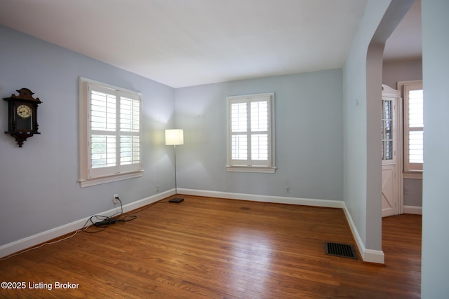 3521 Warner Ave, Louisville, KY 40207 - unfurnished room featuring arched walkways, wood finished floors, and baseboards