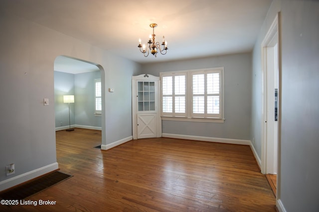 3521 Warner Ave, Louisville, KY 40207 - unfurnished room with arched walkways, a chandelier, wood finished floors, and baseboards