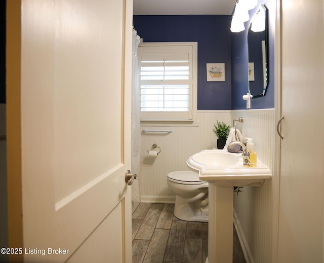 3521 Warner Ave, Louisville, KY 40207 - bathroom with toilet, wainscoting, wood finished floors, and a sink