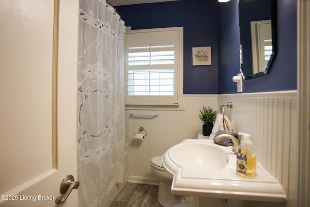 3521 Warner Ave, Louisville, KY 40207 - bathroom with wainscoting, toilet, wood finished floors, and a shower with shower curtain