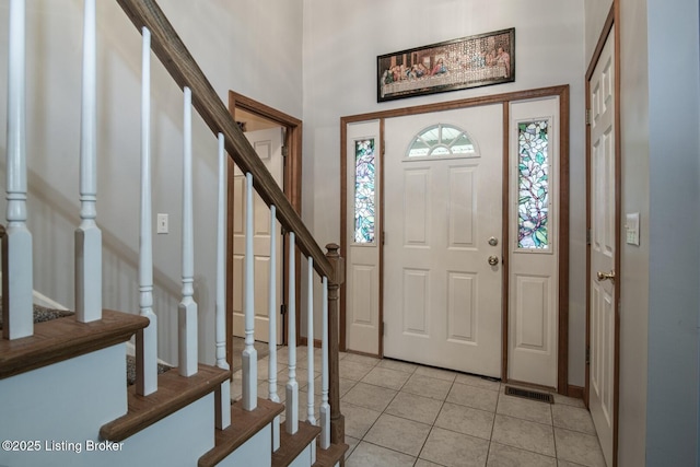 17 Bittersweet Pl, Brandenburg, KY 40108 - entryway featuring stairway, light tile patterned floors, baseboards, and a towering ceiling