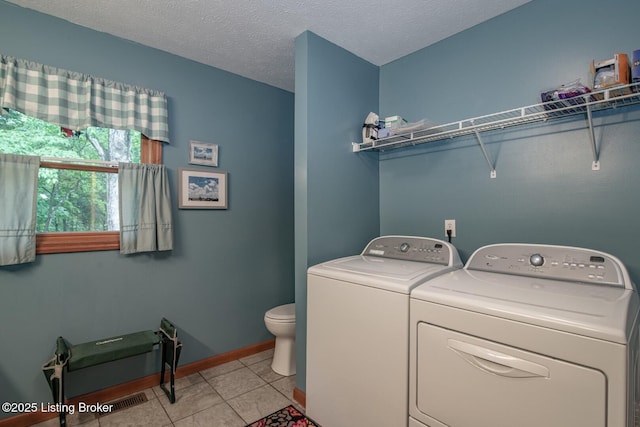 17 Bittersweet Pl, Brandenburg, KY 40108 - laundry area with washer and clothes dryer, light tile patterned floors, baseboards, and a textured ceiling
