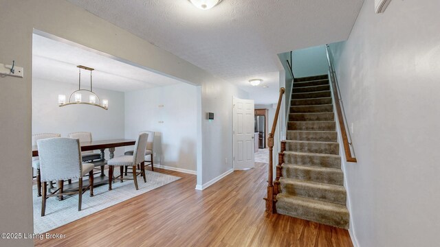 134 Wood Duck Ct, Shepherdsville, KY 40165 - dining area with light wood-style flooring, stairs, baseboards, and a chandelier