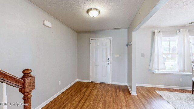 134 Wood Duck Ct, Shepherdsville, KY 40165 - foyer entrance with wood finished floors, baseboards, and a textured ceiling