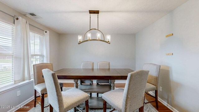 134 Wood Duck Ct, Shepherdsville, KY 40165 - dining space featuring a chandelier, wood finished floors, and baseboards