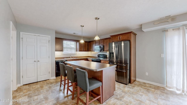 134 Wood Duck Ct, Shepherdsville, KY 40165 - kitchen with black appliances, a sink, stone finish floors, and a kitchen island