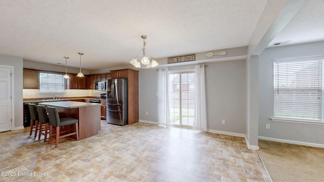 134 Wood Duck Ct, Shepherdsville, KY 40165 - kitchen featuring stainless steel appliances, a center island, light countertops, a kitchen breakfast bar, and baseboards