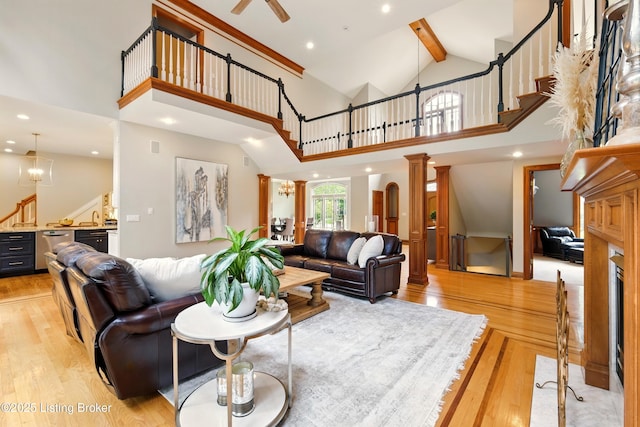 1014 Anchorage Woods Cir, Anchorage, KY 40223 - living room with stairway, beamed ceiling, light wood-style flooring, ornate columns, and high vaulted ceiling
