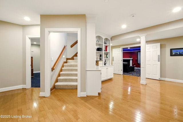 1014 Anchorage Woods Cir, Anchorage, KY 40223 - interior space with light wood finished floors, baseboards, built in shelves, stairs, and recessed lighting