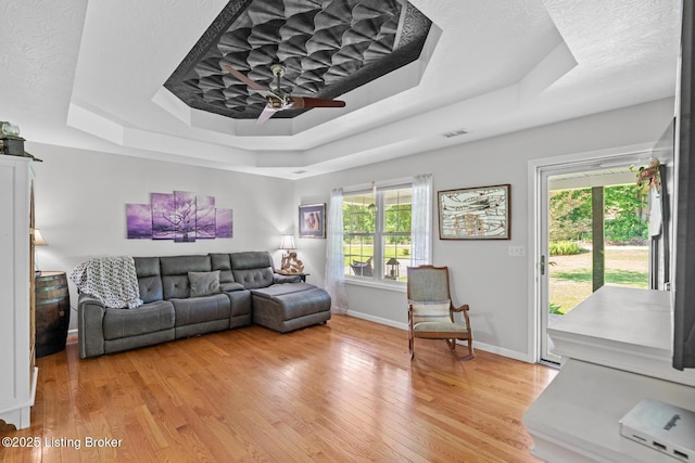 2327 Highgrove Rd, Coxs Creek, KY 40013 - living area with a raised ceiling, light wood-type flooring, a ceiling fan, and baseboards