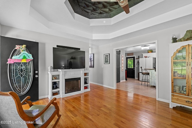 2327 Highgrove Rd, Coxs Creek, KY 40013 - living area featuring healthy amount of natural light, light wood finished floors, a tray ceiling, and baseboards