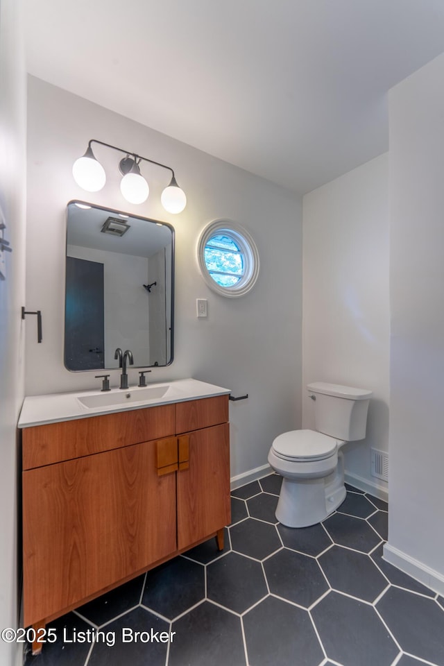 508 Wilderness Rd, Louisville, KY 40214 - bathroom featuring toilet, vanity, and baseboards