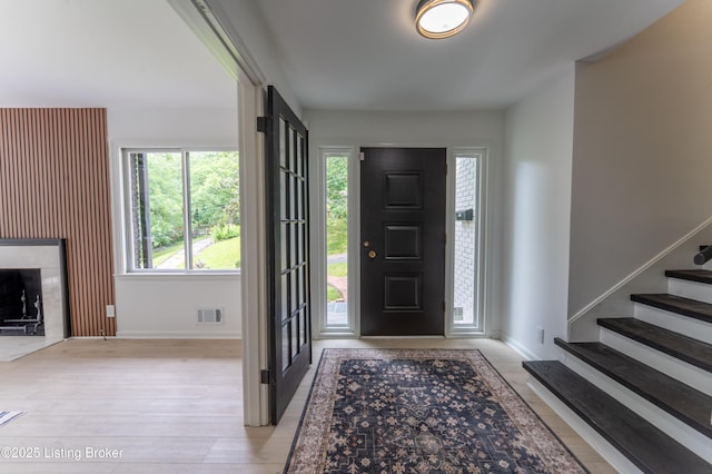 508 Wilderness Rd, Louisville, KY 40214 - foyer with baseboards, a high end fireplace, stairway, and wood finished floors