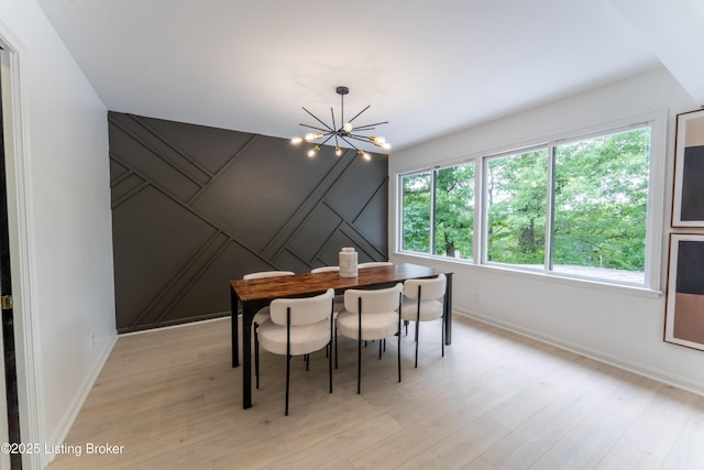 508 Wilderness Rd, Louisville, KY 40214 - dining area featuring a chandelier, light wood-style floors, and baseboards