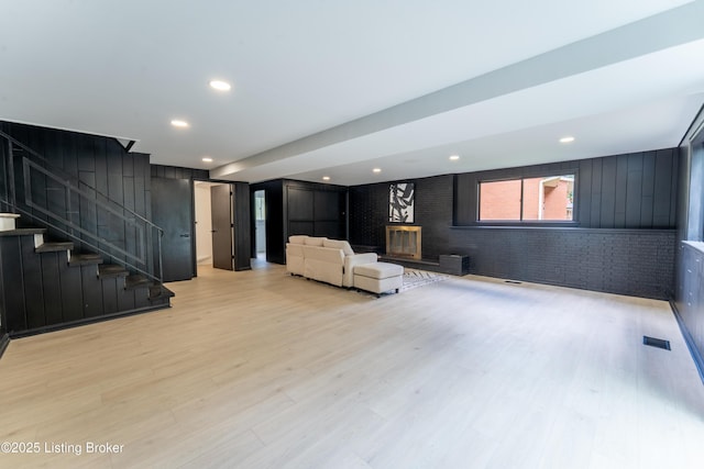 508 Wilderness Rd, Louisville, KY 40214 - basement featuring light wood-style flooring, a brick fireplace, stairway, recessed lighting, and brick wall