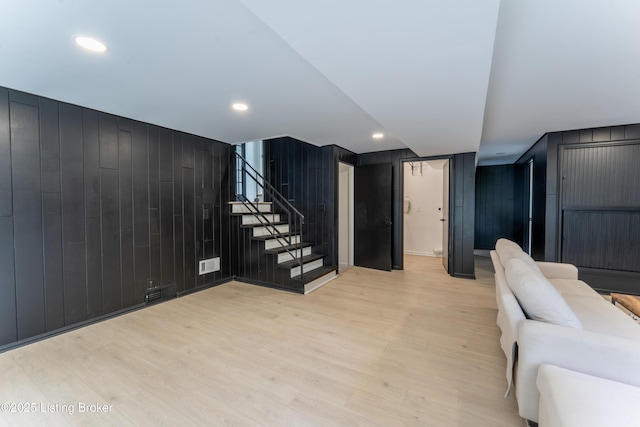 508 Wilderness Rd, Louisville, KY 40214 - living room with light wood-type flooring, stairs, wooden walls, and recessed lighting