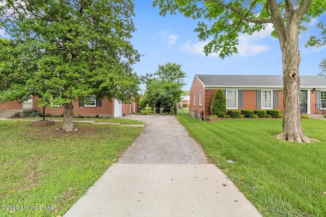 2603 Ballad Blvd, Jeffersontown, KY 40299 - view of front of home with brick siding, asphalt driveway, a front lawn, and an attached garage