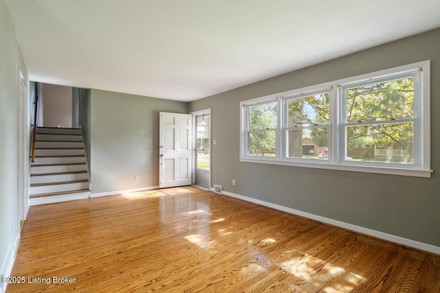 2603 Ballad Blvd, Jeffersontown, KY 40299 - unfurnished living room with baseboards, wood finished floors, and stairway