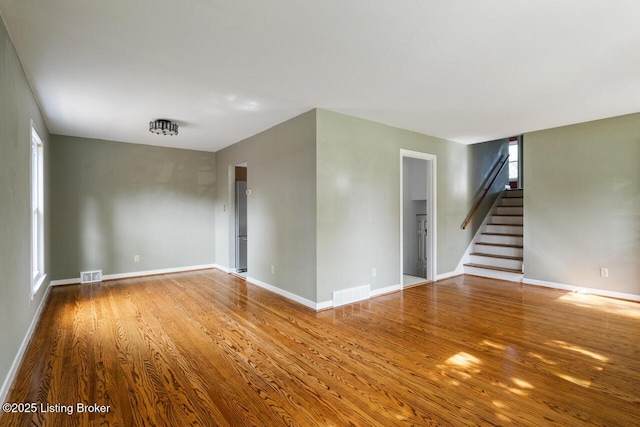 2603 Ballad Blvd, Jeffersontown, KY 40299 - spare room featuring wood finished floors, baseboards, and stairway