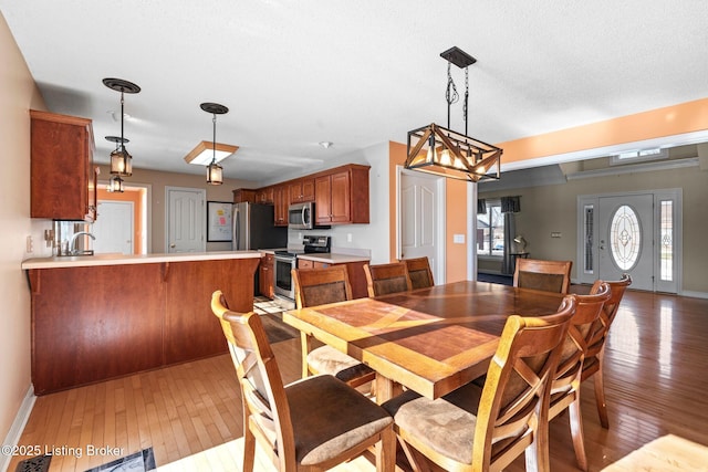 126 Deep Springs Dr, Bardstown, KY 40004 - dining area with light wood-style flooring, a chandelier, and baseboards