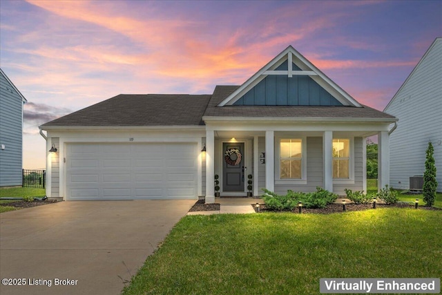 119 Wildflower Ave, Mt Washington, KY 40047 - view of front of home featuring board and batten siding, concrete driveway, a front yard, an attached garage, and a porch