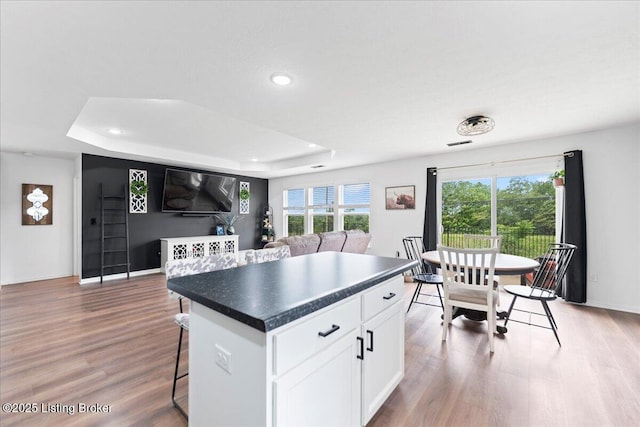 119 Wildflower Ave, Mt Washington, KY 40047 - kitchen featuring a raised ceiling, dark countertops, a breakfast bar area, and recessed lighting
