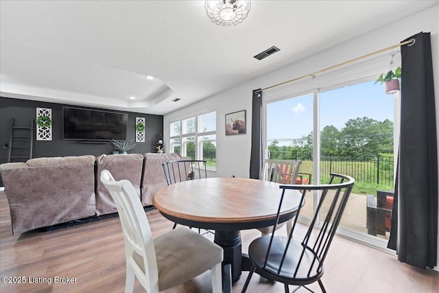 119 Wildflower Ave, Mt Washington, KY 40047 - dining area featuring a raised ceiling, recessed lighting, and light wood-style flooring