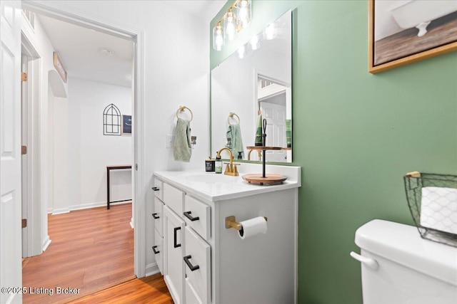 119 Wildflower Ave, Mt Washington, KY 40047 - half bath featuring toilet, vanity, wood finished floors, and baseboards