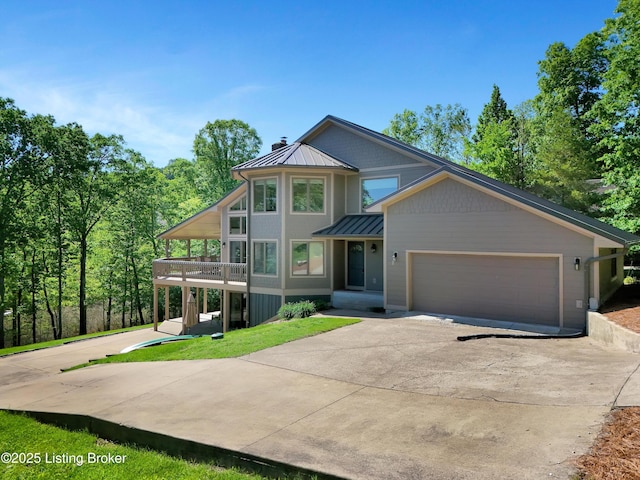 763 Lochober Rd, Leitchfield, KY 42754 - view of front of home with a standing seam roof, concrete driveway, metal roof, a chimney, and a garage